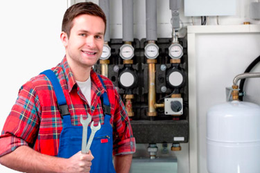 Gas Safe registered heating engineer servicing a gas boiler in Manchester