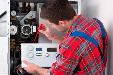 Gas Safe registered heating engineer servicing a gas boiler in Manchester