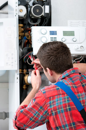 Gas Safe registered heating engineer servicing a gas boiler in Manchester