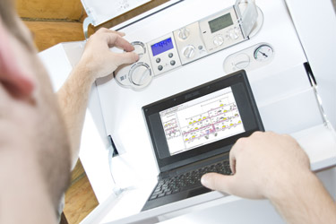 Gas Safe registered heating engineer servicing a gas boiler in Bolton